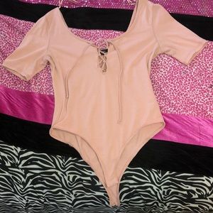 Pink bodysuit, cross cross design